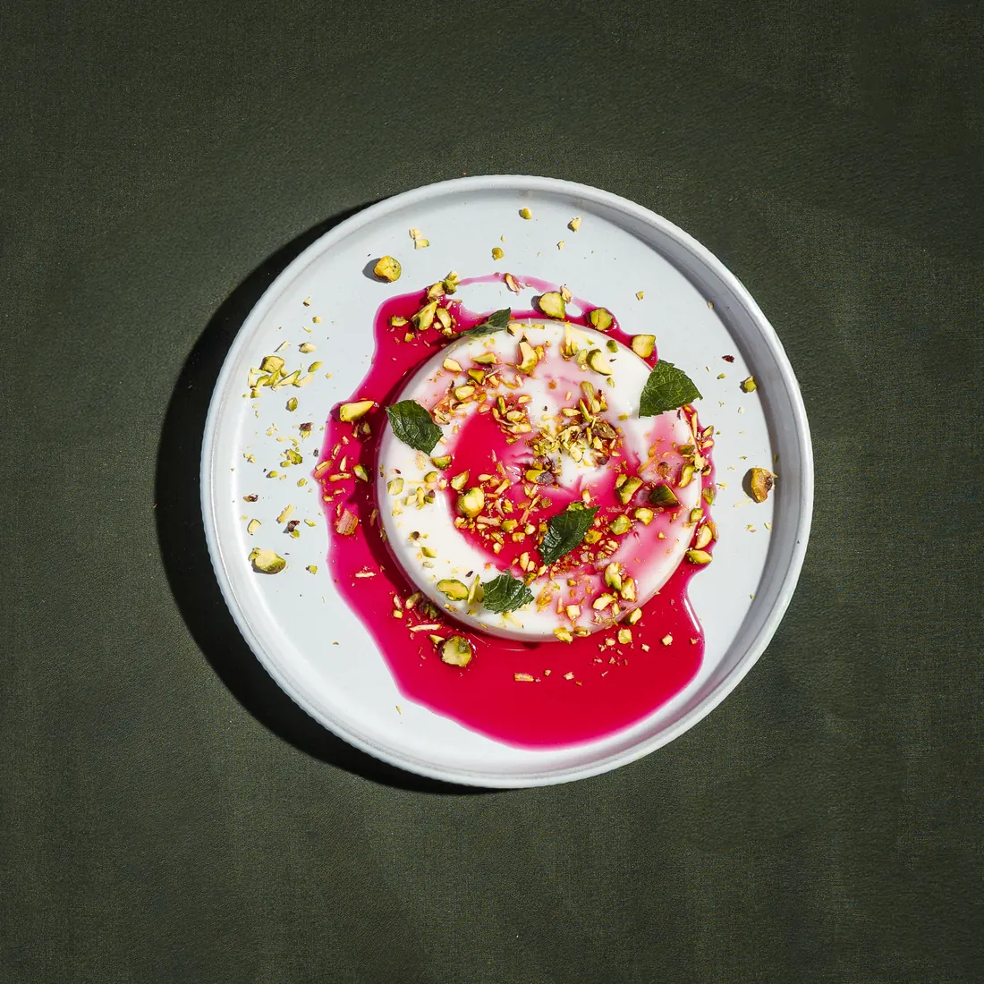 Malabi dessert with rose syrup and crushed pistachio